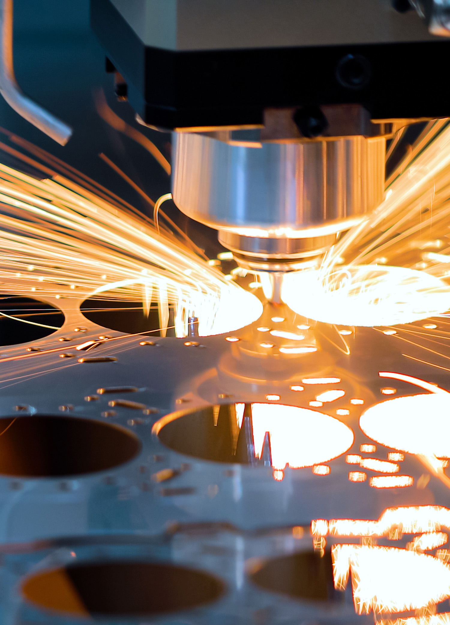 Closeup of sparks flying from a piece of manufacturing equipment